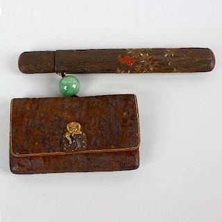 A Japanese smoking set. Comprising pipe with metal mouth piece and bowl, in lacquer case with textur