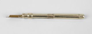 A yellow metal retractable combination pencil and fountain pen, the textured barrel with sliding rin