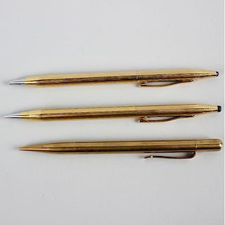 Three yellow metal mechanical pencils. Comprising a pair of Cross examples, each of similar tapering