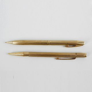 Two 9ct gold mechanical pencils. Comprising a Sheaffer example having engine turned body with vacant