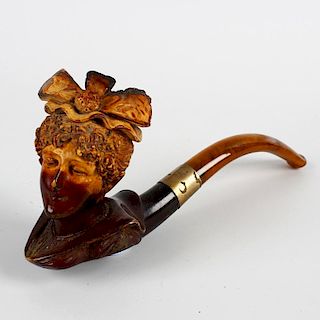A 19th century carved meerschaum pipe. Modelled as a bust of a lady, with ribbon headdress and fashi