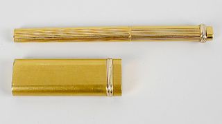 A gold plated Cartier ballpoint pen. Of oblong form having brushed surface to the whole and with gre