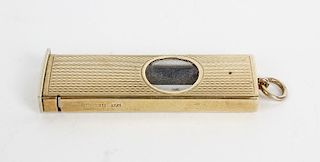 A 1980's 9ct cased cigar cutter. Of rectangular form having textured surface and circular aperture e