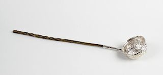 A baleen-handled white metal toddy ladle The repousse bowl inset with a Queen Anne 1708 coin, 13.75,