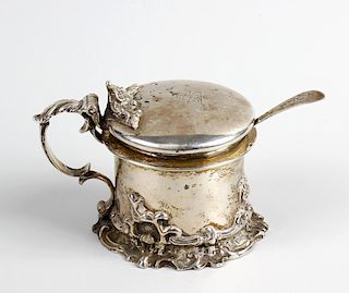 A Victorian silver drum mustard pot. The slightly domed circular cover with foliate thumb piece and