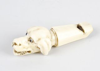 A Victorian ivory whistle, modelled as the head of a dog with open mouth and inset eyes, 3.1, (8cm)