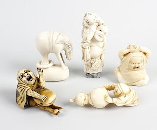 A group of five Japanese netsuke. To include a kneeling figure dragging a large gourd, a horse with