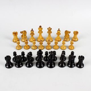 A late 19th century mahogany-cased boxwood and ebony chess set. Of Staunton type, unmarked and unwei