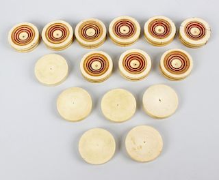 A set of turned and stained ivory counters. Each of circular outline comprising six plain examples a