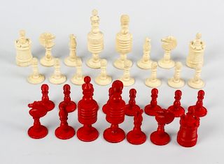 A Captain Cook stained ivory chess set. Comprising natural and red stained sectional pieces, the kin