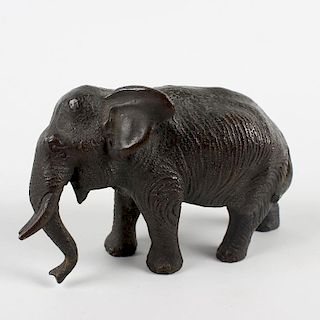 A small cast bronze figure of an elephant. Probably Japanese, Meiji period, modelled in walking pos