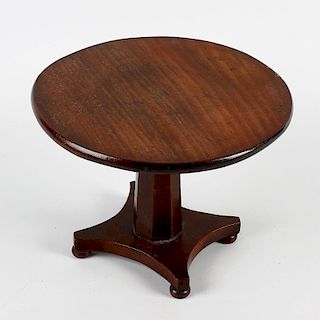 A William IV/early Victorian mahogany miniature centre table. The one-piece circular fixed top on a