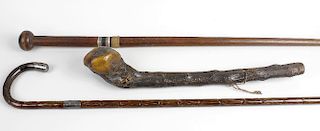 A group of assorted walking sticks, canes and parasols To include a silver-mounted example, a bamboo