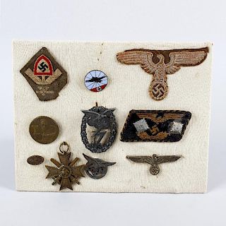 A group of assorted German Third Reich badges. To include fabric and metal examples with eagle and s
