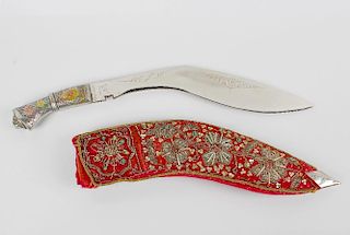 A decorated Indian dagger in scabbard. The painted foliate handle having lion mask terminal leading