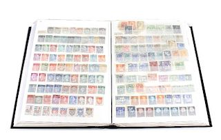 A large mixed album of stamps. To include early 20th century and Victorian examples, plus German, Sw