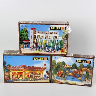 A box containing 13 Faller H0/00 gauge, unassembled plastic model fairground and amusement buildings