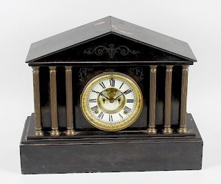 A late 19th century black slate mantel clock. With cream enamel Roman chapter ring framing Brocot es