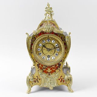 A late 19 century French red tortoiseshell and boulle mantel clock. The 3.25 inch circular dial with