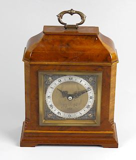 An Elliott walnut mantel clock The 3.5-inch square brass dial with silver chapter ring, having a bac