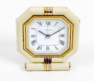 A Cartier desk clock. The octagonal white Roman dial marked CARTIER PARIS, within cushion-moulded su