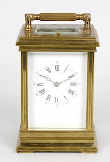 A late 19th century Anglaise-cased brass carriage clock The white dial with Roman hours, Arabic minu