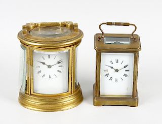 Two brass carriage clocks The first oval, with white Roman dial and single-train timepiece movement