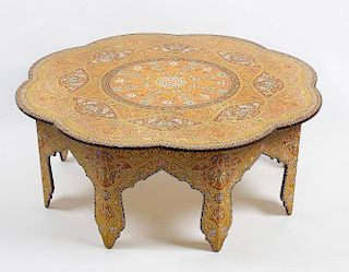A 20th century Russian polychrome-decorated low table. The eight-lobed top with central rosette, flo