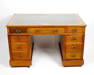 A late Victorian walnut pedestal desk with dated provenance The later gilt-tooled green skiver with
