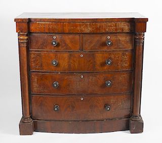 A late 19th century mahogany chest of drawers, the bowed inverted break front fitted with a conceale