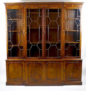 A mahogany reproduction breakfront bookcase cabinet The upper section with dentil cornice and trefoi