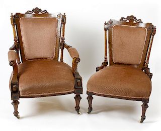A late Victorian carved and inlaid walnut framed armchair, the pink upholstered back, above an overs