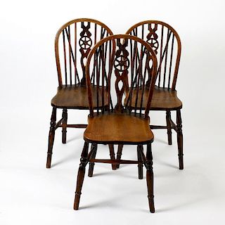 Six early 20th century elm and fruitwood wheel-back Windsor chairs. Each of typical form with saddle