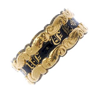 An early 19th century 18ct gold memorial ring. Designed as a central band of text with black enamel