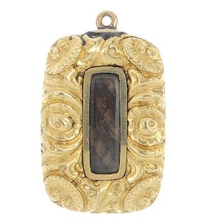 A mid Victorian gold mourning pendant. The rectangular glazed hair panel, to the floral border with