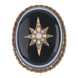 A late 19th century gold split pearl and onyx mourning brooch. The oval-shape onyx cabochon with a s