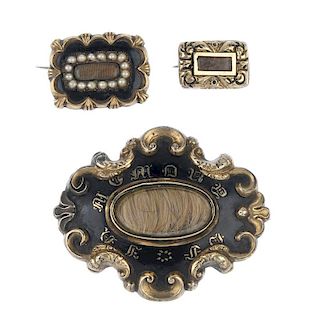 Three mid to late Victorian memorial brooches. The largest with a central oval-shape glazed hair pan