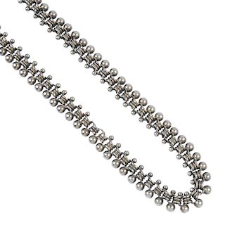 A late 19th century silver collar. Designed as a series of ridged belcher-links, with overlaid cross