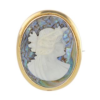 A cameo brooch. Of oval outline, the cameo background in abalone shell with a mother-of-pearl applie
