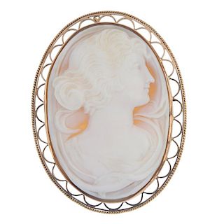 A cameo brooch. Of oval outline, the shell carved to depict a lady with hair tied back, to the scall