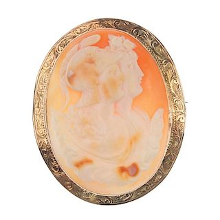 A cameo brooch. The shell carved to depict two Spartan soldiers, to the engraved scrolling border. M