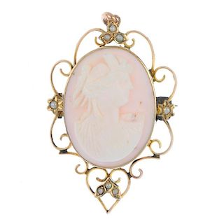 A cameo brooch. The pale pink shell carved to depict the profile of a lady in a classical robe, to t