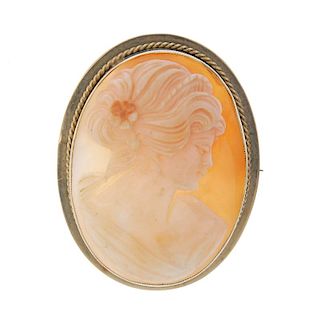 A 9ct gold cameo brooch. Of oval outline carved to depict the side profile of a lady to the rope-twi