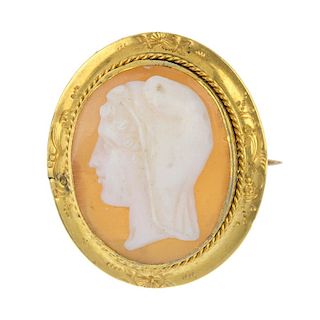 A cameo brooch. Of oval outline, the shell cameo depicting the profile of a hooded man, to the rope-