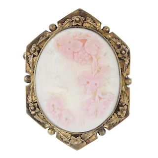A late 19th century conch shell cameo brooch. The oval shell carved to depict Bacchus, to the hexago