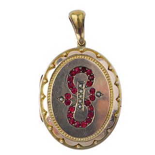 A late 19th century rolled gold locket. Of oval outline, the raised central panel set with red paste
