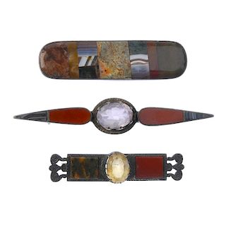 Three agate brooches. To include an elongated oval-shape brooch set with multiple agate pieces, a re