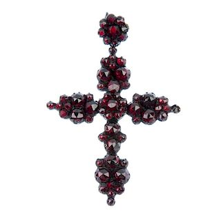 A garnet and paste cross pendant. The cross set with red pastes and garnets to the similarly set sur