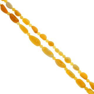 A natural amber necklace. Designed as a series of oval beads, interspaced by circular beads, to the