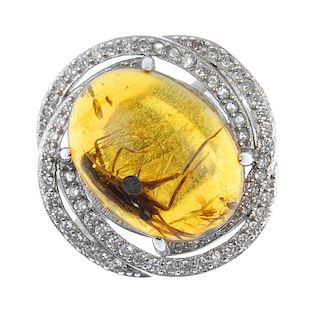 A natural Burmese amber ring with insect inclusion. The amber cabochon measuring 1.4cms, with clearl